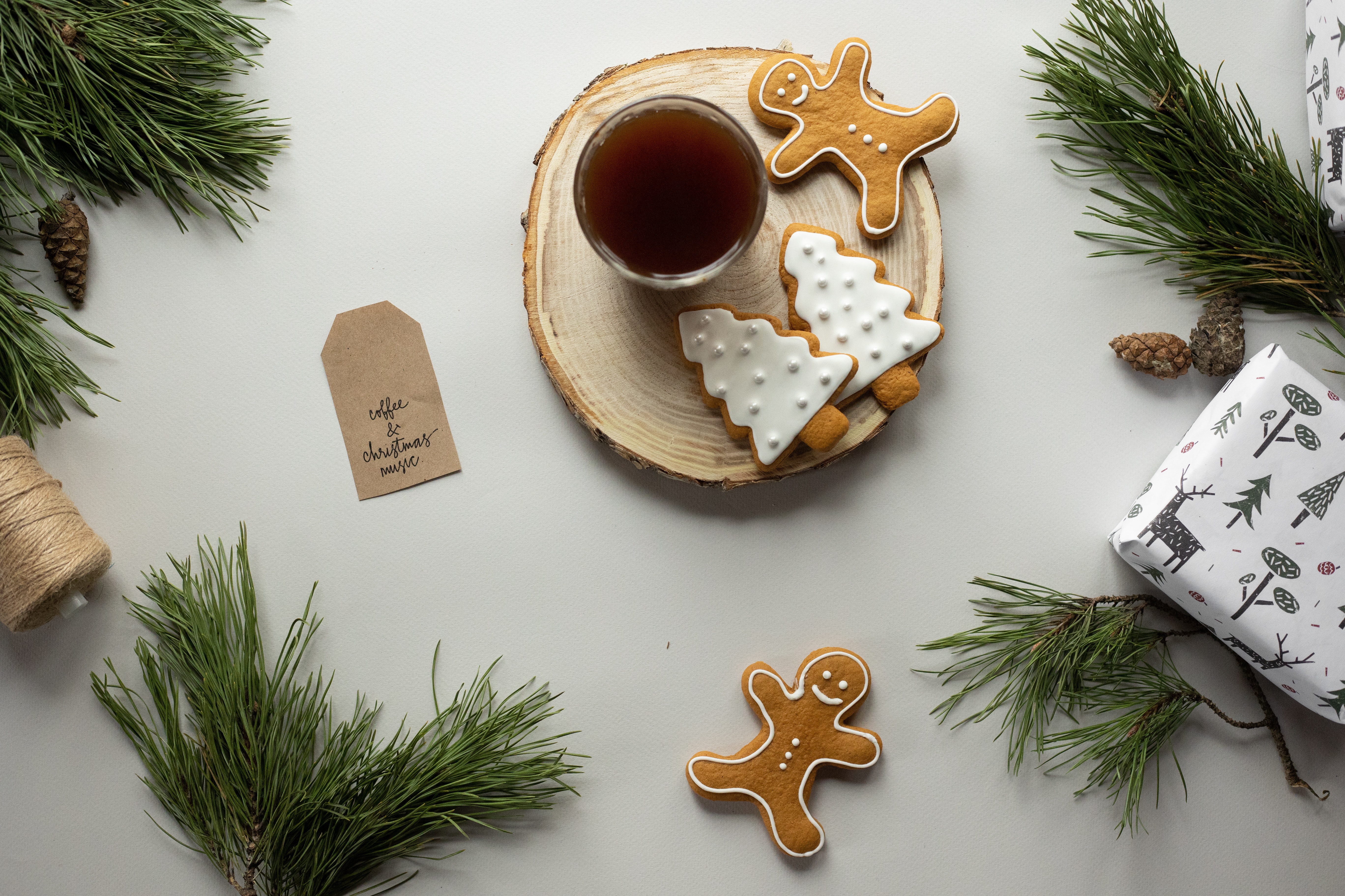 gingerbread men cookies on table with pine tree branches